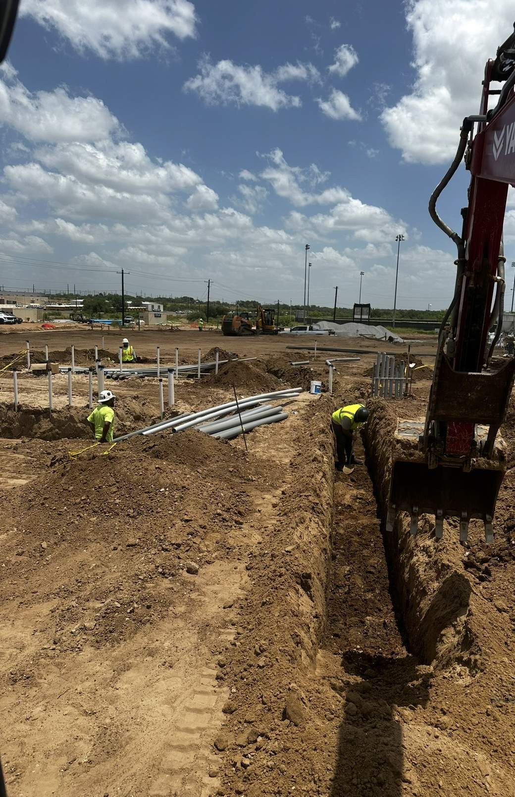 SF Excavation crew cutting a utility trench on a commercial job site in San Antonio, Texas