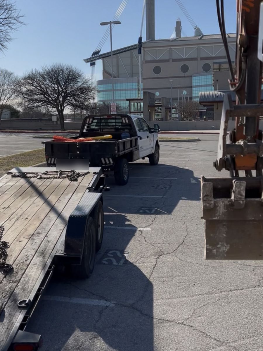 SF Excavation truck and excavator mobilizing for a job in downtown San Antonio, Texas